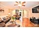 Spacious living room featuring hardwood floors, comfortable seating, and a ceiling fan at 5344 Saddlewood Ln, Mint Hill, NC 28227
