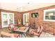 View of a furnished screened porch featuring brick walls, a ceiling fan, and ample natural light at 5344 Saddlewood Ln, Mint Hill, NC 28227