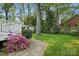 Spacious backyard featuring a lush lawn, mature trees, and a garden shed at 5400 Glenham Dr, Charlotte, NC 28210