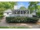 Attractive backyard featuring a screened porch and lush landscaping at 5400 Glenham Dr, Charlotte, NC 28210