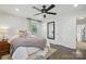 Bright bedroom with white walls, dark hardwood floors, and a ceiling fan at 5400 Glenham Dr, Charlotte, NC 28210