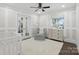 Cozy Bedroom with white paneled walls, and a light gray accent chair at 5400 Glenham Dr, Charlotte, NC 28210