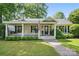 Inviting single-story house featuring a covered porch with rocking chairs and swing at 5400 Glenham Dr, Charlotte, NC 28210