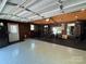 Garage featuring painted floors, paneled walls, and a home gym setup at 5400 Glenham Dr, Charlotte, NC 28210