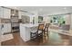 Kitchen and living room view. Features stainless appliances, stone counters, eat in bar and open concept living at 5400 Glenham Dr, Charlotte, NC 28210