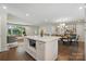 Kitchen island with view to living room. Features stone counters, microwave, and view to open floor plan at 5400 Glenham Dr, Charlotte, NC 28210