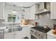 Bright kitchen featuring stainless steel appliances, gas range, white cabinets and a stainless steel basin sink at 5400 Glenham Dr, Charlotte, NC 28210