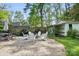 Large patio area with Adirondack chairs, a fire pit, and a detached shed at 5400 Glenham Dr, Charlotte, NC 28210