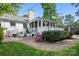 Charming patio area with brick pavers, screened porch, and beautiful landscaping at 5400 Glenham Dr, Charlotte, NC 28210