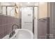 Bathroom showcasing a glass shower and tiled walls at 631 Dogwood Rd, Statesville, NC 28677