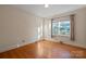 Bright bedroom showcasing hardwood floors and a large window with beautiful curtains at 631 Dogwood Rd, Statesville, NC 28677