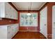 Charming breakfast nook features white cabinets and drawers, hardwood floor and a bright window view at 631 Dogwood Rd, Statesville, NC 28677