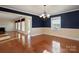Dining room showcases hardwood floors, elegant chandelier, and seamless transition to the living area at 631 Dogwood Rd, Statesville, NC 28677