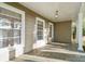 Covered front porch featuring stone flooring, beadboard ceiling, and abundant natural light through multiple windows at 631 Dogwood Rd, Statesville, NC 28677