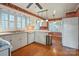 Cozy kitchen features white cabinets, hardwood flooring, stainless steel appliances, and a bright window view at 631 Dogwood Rd, Statesville, NC 28677