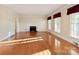 Bright living room featuring hardwood floors, fireplace, large windows, and neutral wall color at 631 Dogwood Rd, Statesville, NC 28677