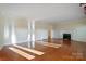 Spacious living room showcasing hardwood floors, a classic fireplace, and abundant natural light at 631 Dogwood Rd, Statesville, NC 28677