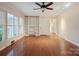 Spacious living room with hardwood floors, built-in shelving, and bright natural light from large windows at 631 Dogwood Rd, Statesville, NC 28677