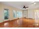 Spacious living room with hardwood floors, built-in shelving, and bright natural light from large windows at 631 Dogwood Rd, Statesville, NC 28677