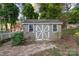 Detached shed in backyard with double doors, windows, and stone pathway at 631 Dogwood Rd, Statesville, NC 28677