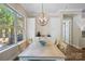 Open dining area with an elegant pendant light and a view of the fenced yard and grill at 650 Tallulah Falls Dr, Denver, NC 28037