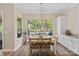 Bright dining area with natural light and a view of the pool and lush backyard landscape at 650 Tallulah Falls Dr, Denver, NC 28037