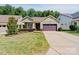 Charming home exterior featuring a well-manicured lawn, a two-car garage, and inviting curb appeal at 650 Tallulah Falls Dr, Denver, NC 28037