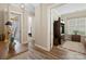 Hallway featuring hardwood floors, neutral paint, and decorative accents offering easy access to rooms at 650 Tallulah Falls Dr, Denver, NC 28037