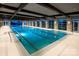 Beautiful indoor swimming pool with natural light, beamed ceilings, and ample deck space at 650 Tallulah Falls Dr, Denver, NC 28037