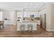Kitchen includes white cabinetry, granite countertops, stainless steel appliances, and eat in bar with seating at 650 Tallulah Falls Dr, Denver, NC 28037