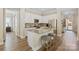 Kitchen features white cabinetry, granite countertops, stainless steel appliances, and eat in bar with seating at 650 Tallulah Falls Dr, Denver, NC 28037