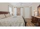 Well-lit main bedroom featuring an en suite bath and a sliding barn door closet at 650 Tallulah Falls Dr, Denver, NC 28037