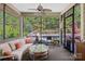 Relaxing sunroom with comfortable wicker furniture overlooking a beautiful swimming pool and landscaped backyard at 650 Tallulah Falls Dr, Denver, NC 28037