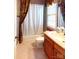 Tiled bathroom with vanity and shower featuring a curtain at 708 Ridgelake Dr, Weddington, NC 28104