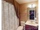 Bathroom with vanity, mirror, shower with curtain, and decorated walls at 708 Ridgelake Dr, Weddington, NC 28104