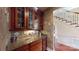 Butler's pantry with custom cabinetry, granite countertop, and decorative glass-front cabinets at 708 Ridgelake Dr, Weddington, NC 28104