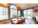 Bright dining room featuring a chandelier, a wooden table set for six, and large windows with natural light at 708 Ridgelake Dr, Weddington, NC 28104