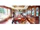 Elegant dining room featuring a long, beautifully set table, ornate chandelier, and a classic china cabinet at 708 Ridgelake Dr, Weddington, NC 28104