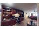 Well-appointed home office featuring custom built-in shelving, a spacious desk, and comfortable seating, perfect for productivity at 708 Ridgelake Dr, Weddington, NC 28104