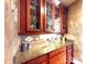 Close up of granite countertops and custom wooden cabinetry with designer hardware and tile backsplash at 708 Ridgelake Dr, Weddington, NC 28104