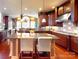 Elegant kitchen with custom cabinets, granite countertops, stainless appliances, and hardwood floors at 708 Ridgelake Dr, Weddington, NC 28104