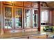 Detailed view of kitchen's custom glass door cabinets, granite counters, and nearby planters at 708 Ridgelake Dr, Weddington, NC 28104