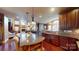 Gourmet kitchen featuring custom cabinetry, granite countertops, stainless steel appliances, and a center island with seating at 708 Ridgelake Dr, Weddington, NC 28104