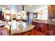 Spacious kitchen featuring a large center island, granite countertops, custom cabinets, and modern appliances at 708 Ridgelake Dr, Weddington, NC 28104