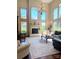 Spacious living room features a fireplace, large windows, and a beautiful chandelier at 708 Ridgelake Dr, Weddington, NC 28104