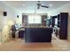 Large living room with leather sofas, ceiling fans, and built-in shelving at 708 Ridgelake Dr, Weddington, NC 28104