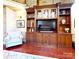Cozy living room with custom wood built-ins for storage, and rich hardwood floors at 708 Ridgelake Dr, Weddington, NC 28104