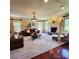 Elegant living room with a fireplace, hardwood floors, and natural light streaming through the windows at 708 Ridgelake Dr, Weddington, NC 28104