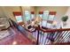 Stunning living room with fireplace, high ceilings, and large windows showcasing abundant natural light from the staircase landing at 708 Ridgelake Dr, Weddington, NC 28104