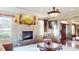 Elegant living room with a stone fireplace, large windows, and hardwood floors at 708 Ridgelake Dr, Weddington, NC 28104